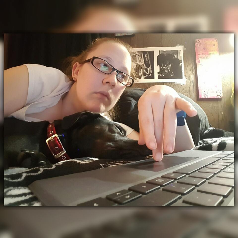 Online freelance writer with her dog beside her napping