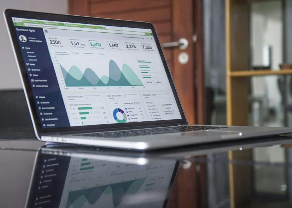 Web analytics tool showing statistics on a laptop screen.